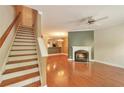 Cozy living room with hardwood floors, fireplace, staircase, and an open floor plan at 3094 Lauren Parc Rd, Decatur, GA 30032