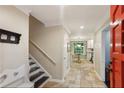 Hallway with tile flooring leads to the kitchen and dining nook beyond the open red front door at 358 W West Wind Sw Dr, Lilburn, GA 30047