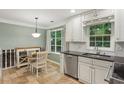 Bright kitchen features white cabinets, dark countertops, and a cozy breakfast nook with plenty of natural light at 358 W West Wind Sw Dr, Lilburn, GA 30047