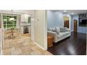 Open floorplan featuring tile flooring connecting the kitchen and hardwood flooring in living room at 358 W West Wind Sw Dr, Lilburn, GA 30047