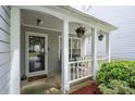 Welcoming covered front porch with white columns and a seating area at 6606 Coventry Pt, Austell, GA 30168