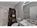 Clean, functional bathroom features a shower-tub combo and a vanity sink with a large mirror at 2090 Marbut Ln, Lithonia, GA 30058