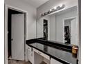 Bathroom vanity featuring ample countertop space, cabinets, and a large mirror with vanity lighting at 2090 Marbut Ln, Lithonia, GA 30058