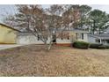 Charming single-story home with a well-kept lawn, features a convenient one-car garage at 2090 Marbut Ln, Lithonia, GA 30058