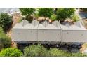 Aerial view of townhomes with gray roofs, surrounded by lush trees and well-maintained grounds at 2625 Cedar Dr, Lawrenceville, GA 30043