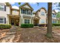 A well maintained townhouse featuring lush greenery and a welcoming front entrance at 2625 Cedar Dr, Lawrenceville, GA 30043