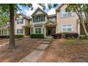 Attractive townhome showcasing manicured landscaping and inviting curb appeal on a sunny day at 2625 Cedar Dr, Lawrenceville, GA 30043
