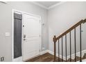 Bright entryway featuring hardwood floors, staircase, and a closet with storage at 7762 Fawn Cir, Covington, GA 30014