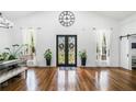 Bright entryway with high ceilings, hardwood floors, grand double doors and lovely decor at 4439 Luther Ward Rd, Powder Springs, GA 30127