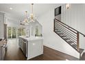 Modern kitchen island with sleek countertops and a staircase with black metal railings at 2335 Mason Dr # D27, Atlanta, GA 30316