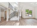 Open concept living area with high ceilings, sleek black stair railing, and light wood floors at 2934 Wendover St, Marietta, GA 30062