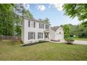 Traditional two-story home featuring white siding, dark shutters, and an inviting front yard landscape at 303 Cimarron Way, Lawrenceville, GA 30044