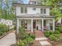 Beautifully landscaped home with brick stairs leading to a cozy covered front porch at 686 Amsterdam Ne Ave, Atlanta, GA 30306