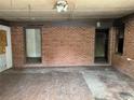 Unfinished living room with a brick accent wall, paint swatches, and unfinished ceilings at 1405 Mote Rd, Covington, GA 30016