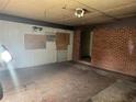 Unfinished living room with a brick accent wall, paint swatches, and unfinished ceilings at 1405 Mote Rd, Covington, GA 30016
