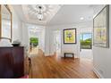 Elegant foyer with hardwood floors, decorative lighting, and framed artwork, offering a warm welcome at 2660 Peachtree Rd # 7F, Atlanta, GA 30305