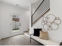 Modern foyer with a view of the staircase, stylish bench and art decoration at 420-D Parkway Ne Dr, Atlanta, GA 30308
