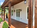 Inviting front porch features wood columns, outdoor lighting, and light-blue double front doors at 50 Maple St, Roswell, GA 30075