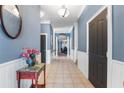Inviting hallway featuring decorative wall trim, tile floors, and elegant lighting fixtures at 832 Chalet Hls, Mcdonough, GA 30253
