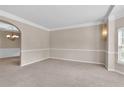 Spacious living area features neutral tones, plush carpet, and seamless transition to adjacent spaces at 105 Tanners Ct, Covington, GA 30016