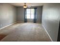 Living room features carpeted floors, a ceiling fan, and a large window at 14301 Waldrop Cv, Decatur, GA 30034