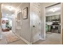 Hallway view with light grey walls connecting to a kitchen and living area at 2474 Lehaven Dr, Tucker, GA 30084