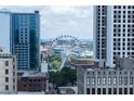 View of city buildings and a large Ferris wheel from an elevated vantage point at 57 Forsyth Nw St # 12B, Atlanta, GA 30303