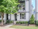Charming two-story townhome featuring a balcony, black accents, and well-maintained landscaping at 915 Katie Kerr Drive, Decatur, GA 30030