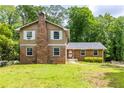 Two-story brick home featuring a well-kept lawn and a brick chimney at 440 Ohern Ct, Stone Mountain, GA 30088