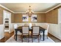 Elegant dining room with wainscoting and designer chandelier at 4627 Angelo Ne Dr, Atlanta, GA 30319