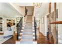 Grand foyer with staircase, hardwood floors, and elegant lighting at 4627 Angelo Ne Dr, Atlanta, GA 30319
