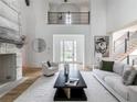 Bright living room with tall ceilings and a stone fireplace at 464 Pine Tree Ne Dr, Atlanta, GA 30305