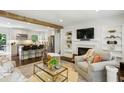 Bright living room featuring a fireplace, open shelving, and a view of the adjacent kitchen at 960 Lindridge Ne Dr, Atlanta, GA 30324