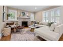 Bright living room features hardwood floors, fireplace, built-in shelving, and plantation shutters at 97 Peachtree Hills Ne Ave, Atlanta, GA 30305