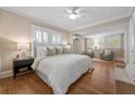 Spacious main bedroom with hardwood floors, large windows, ceiling fan, and ensuite sitting area at 97 Peachtree Hills Ne Ave, Atlanta, GA 30305