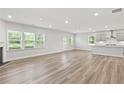 Open living area with fireplace and light wood floors leading to the kitchen at 205 Kindness Cir, Mcdonough, GA 30252