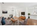 Bright, open living room with hardwood floors, a fireplace, and modern furnishings, creating a cozy and inviting space at 6080 Indian Wood Se Cir, Mableton, GA 30126