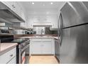 Compact kitchen with stainless steel appliances and white cabinets at 70 Old Ivy Ne Rd # 29, Atlanta, GA 30342