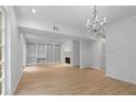 Bright living room featuring hardwood floors, a fireplace, and built-in shelving at 70 Old Ivy Ne Rd # 29, Atlanta, GA 30342