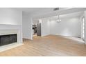 Open living room with fireplace and stainless steel kitchen appliances in the background at 70 Old Ivy Ne Rd # 29, Atlanta, GA 30342