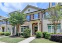 Charming townhome with manicured lawn, brick accents, and inviting entrance at 7725 Pierpoint Ln, Alpharetta, GA 30005