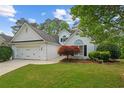 Beautiful home exterior with lush green lawn and mature trees at 9889 Between The Grns, Villa Rica, GA 30180