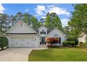 Charming brick home with well-manicured lawn and attached two car garage at 9889 Between The Grns, Villa Rica, GA 30180