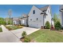 Charming white two-story home with a spacious driveway and manicured lawn at 208 Idylwilde Way, Canton, GA 30115