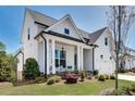 Side view of a charming white two-story home with a manicured lawn at 208 Idylwilde Way, Canton, GA 30115