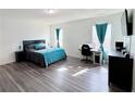Spacious bedroom with a comfortable bed, hardwood floors, and natural light at 3785 Newbury Place Dr, Loganville, GA 30052