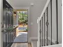 Inviting entryway with stylish staircase, decorative iron spindles, and a view of the exterior at 506 Tallapoosa Trl, Woodstock, GA 30188