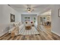Spacious living room with wood floors, plenty of natural light, and open access to dining area at 506 Tallapoosa Trl, Woodstock, GA 30188