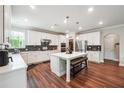 Bright, open kitchen with white cabinets, large island and stainless steel appliances at 6375 Haystack Ct, Cumming, GA 30040