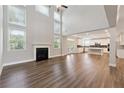 Bright and airy living room with fireplace flows into the kitchen at 6375 Haystack Ct, Cumming, GA 30040